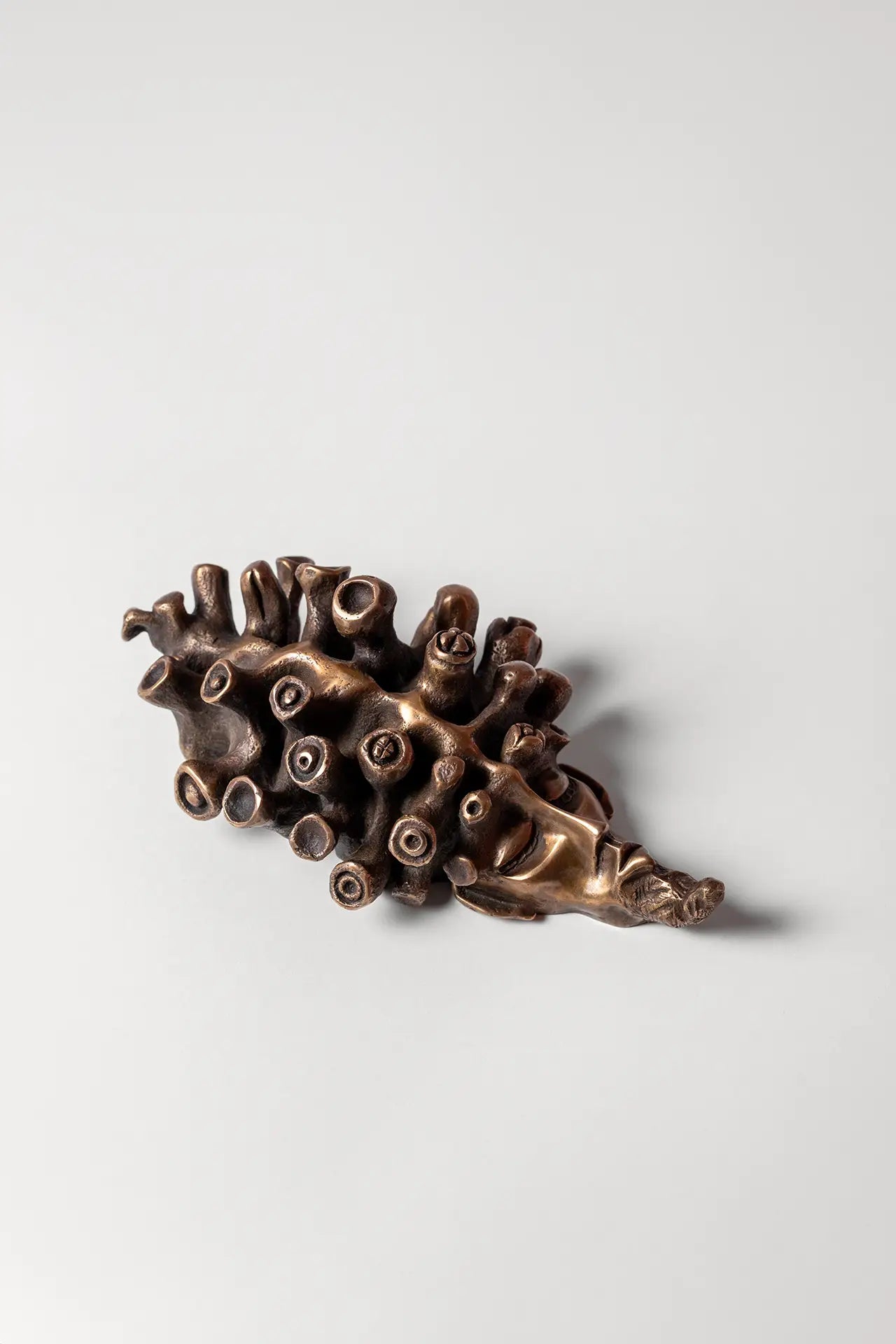 The Dreamer sculpture – surreal bronze mask wall art